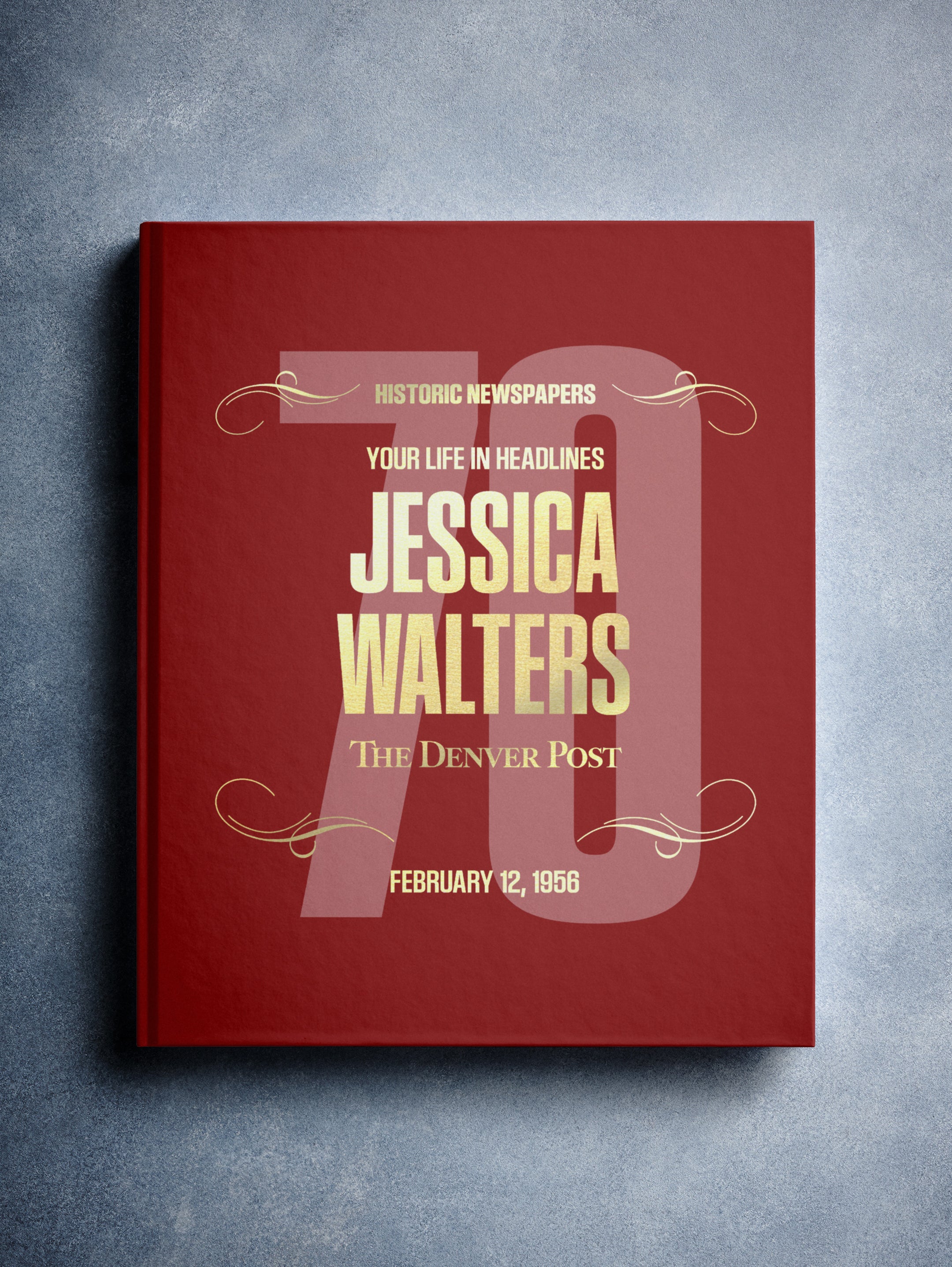 Personalized Denver Post birthday newspaper book with maroon foil cover, featuring historic newspaper pages and custom name engraving.