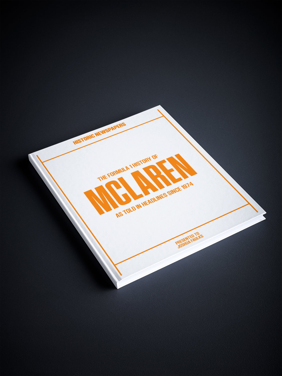 Close-up of "The Formula 1 History of McLaren" POD book by Historic Newspapers on a white background.