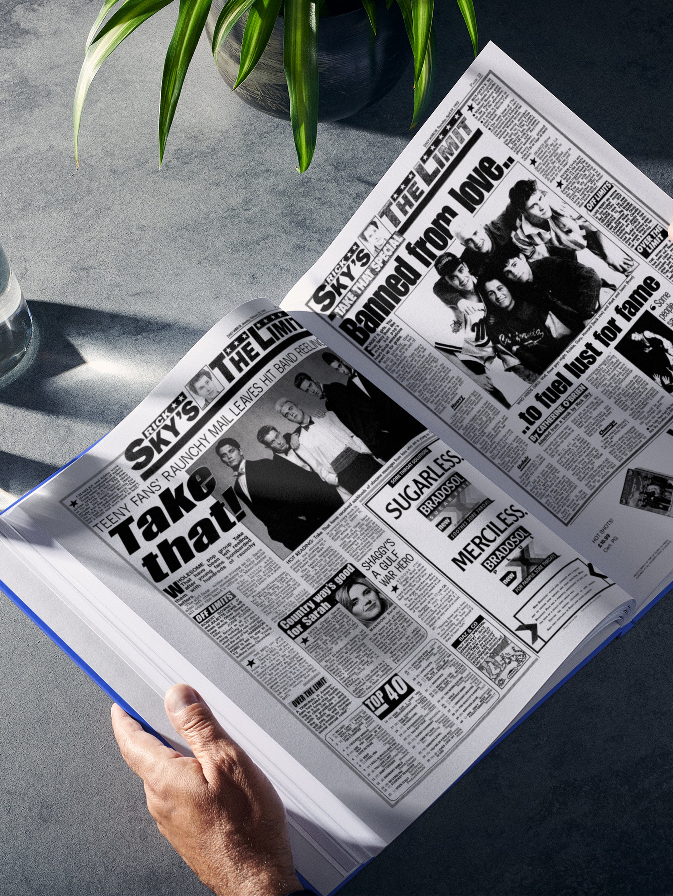 POD book titled "The Story of Take That" by Historic Newspapers, featuring a blue cover with images of the band and music-themed design.