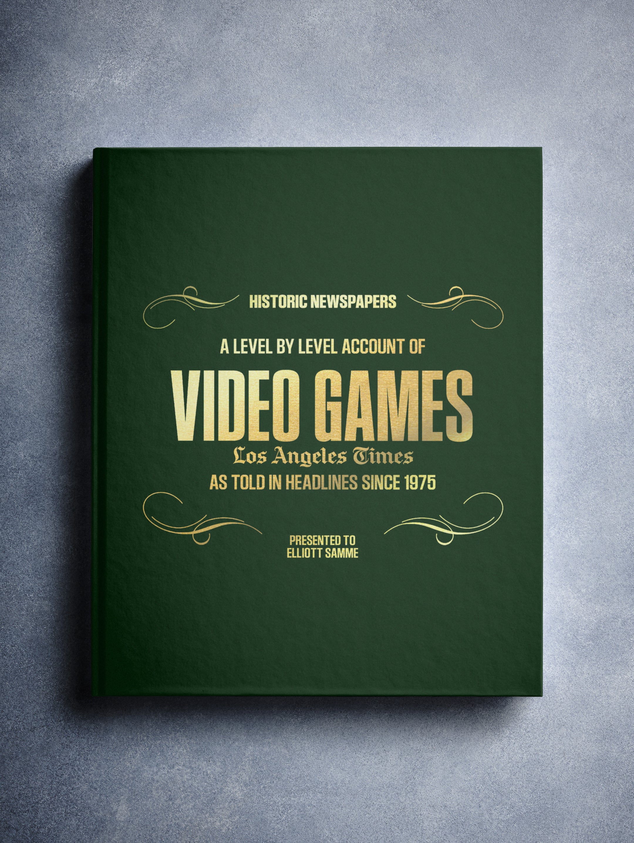 Historic Newspapers POD book titled "The History of Video Games" Los Angeles Times Edition, with a dark green foil cover on newsstand display.