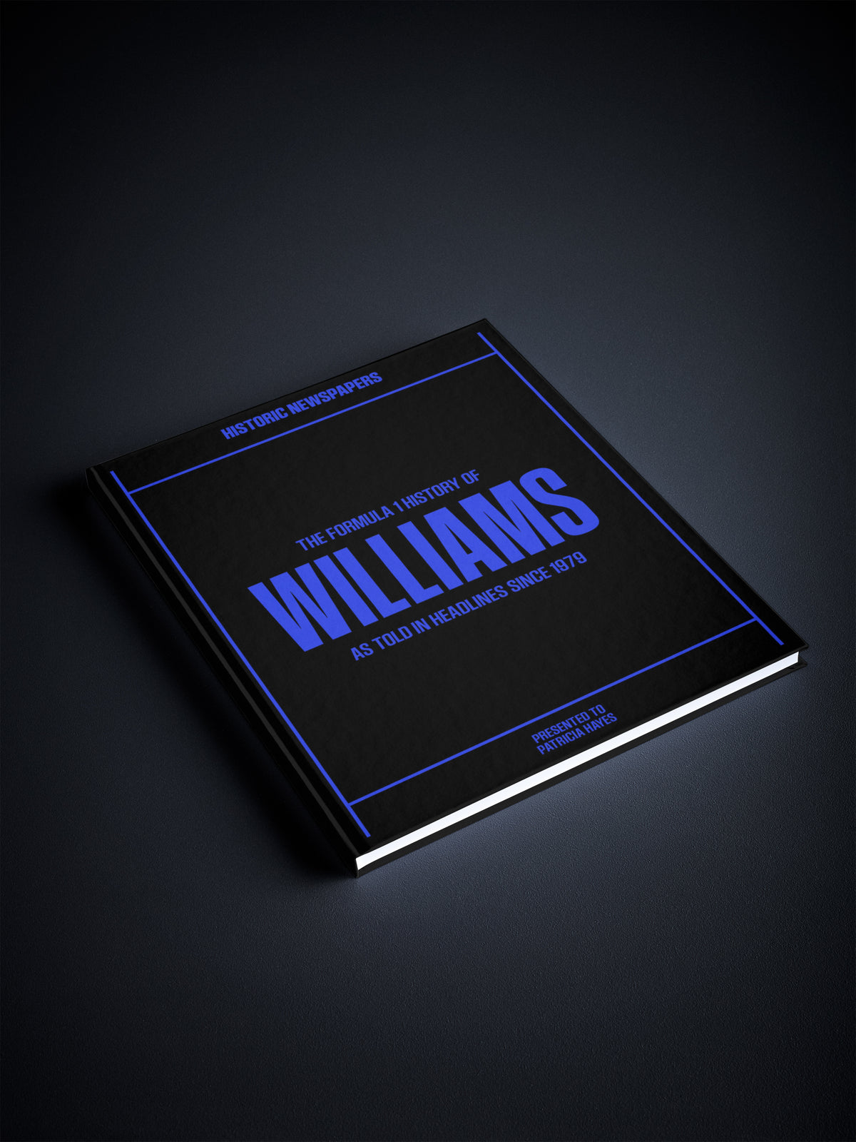 Black and white image of The Formula 1 History of Williams POD book by Historic Newspapers on a newsstand display.