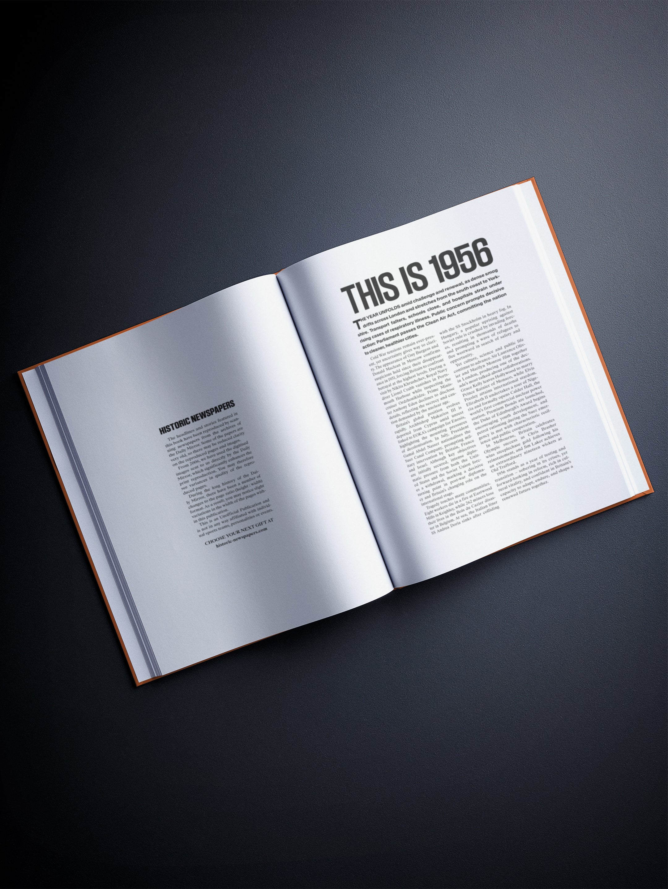 Open copy of "Your Year in Headlines 1956" POD book by Historic Newspapers with colorful mirror-red cover and historic newspaper headlines.