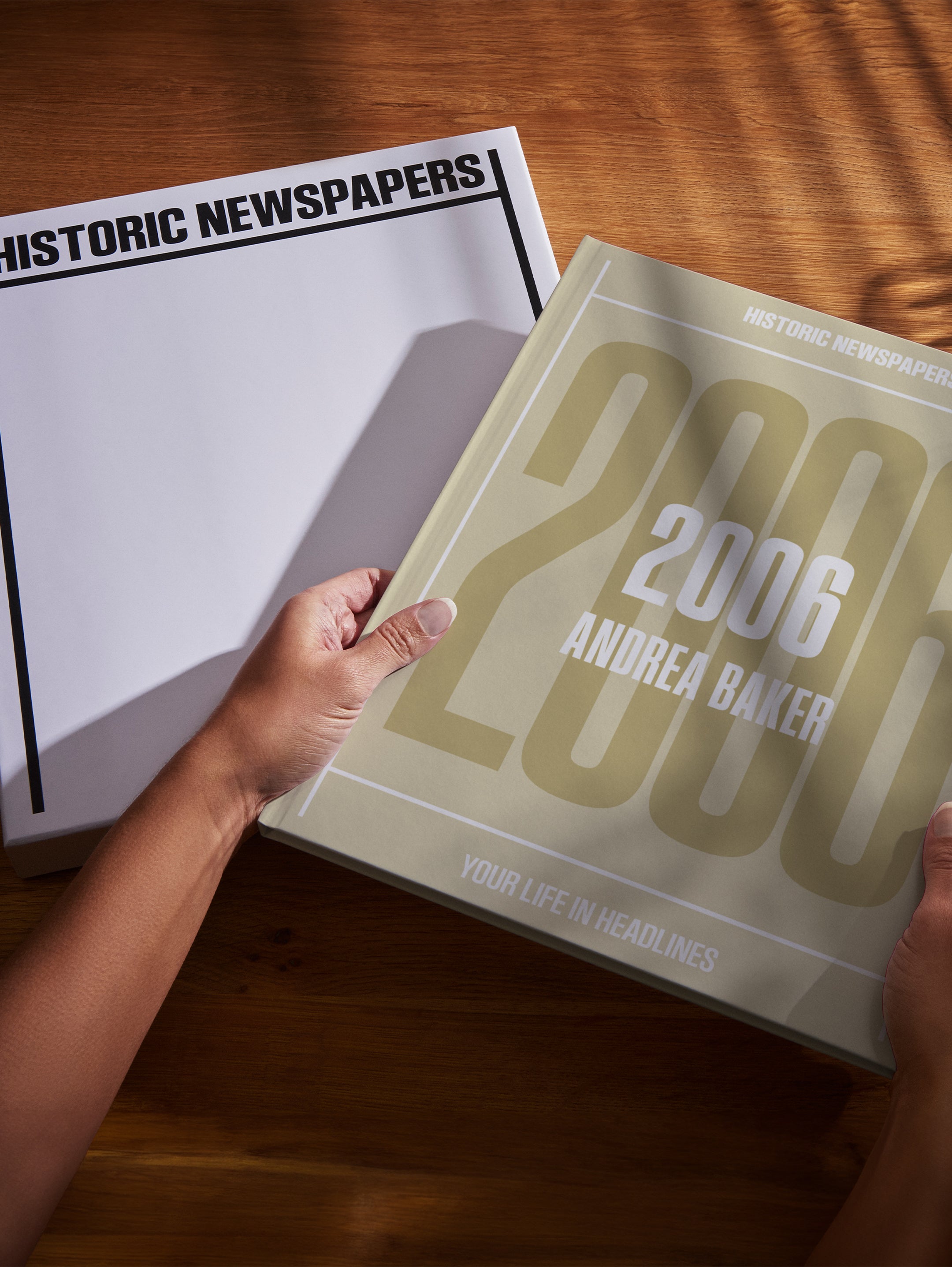 Open copy of Your Year in Headlines 2006 POD book by Historic Newspapers in a gift box, with newspaper headlines from 2006.
